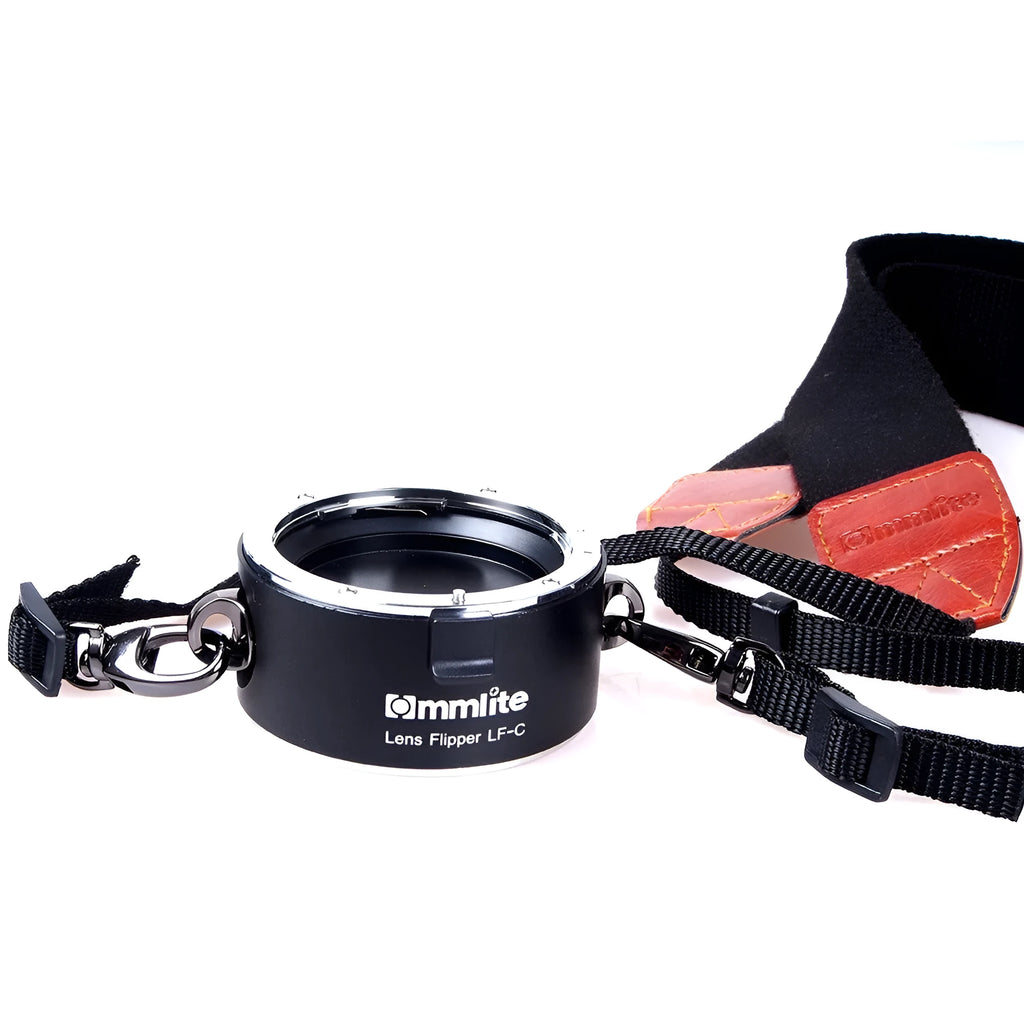 Aluminium camera lens flipper holder with two lenses attached on a cotton shoulder strap.