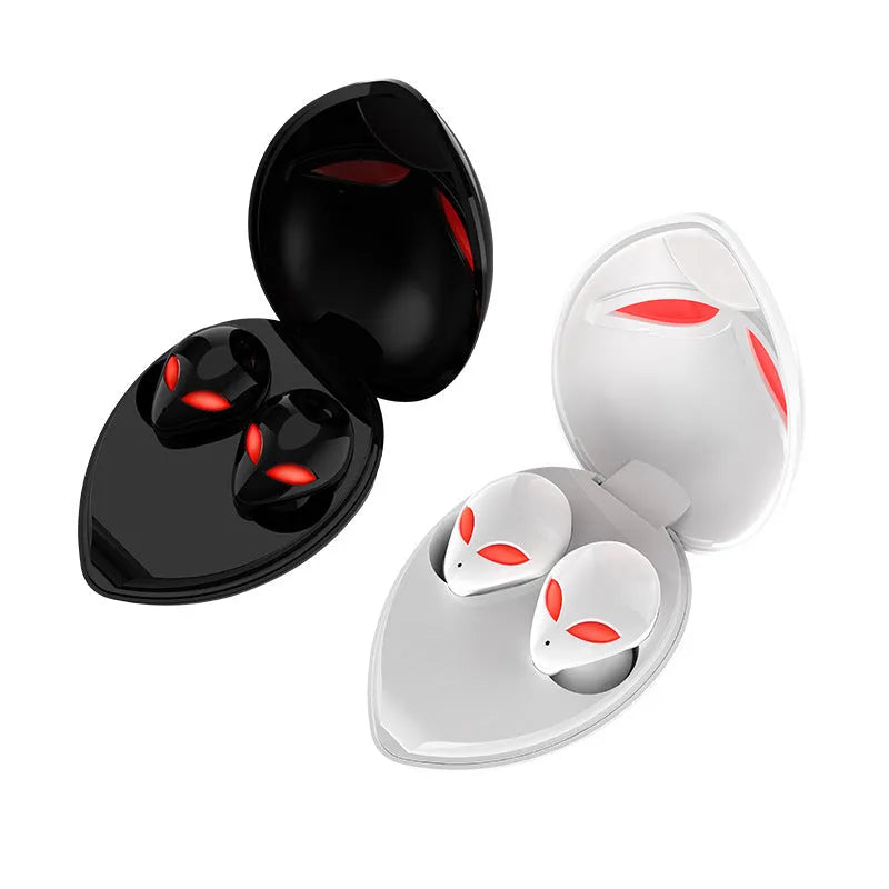Creative Outer T8 Starman alien-shaped Bluetooth earbuds with LED lights next to their wireless charging case.