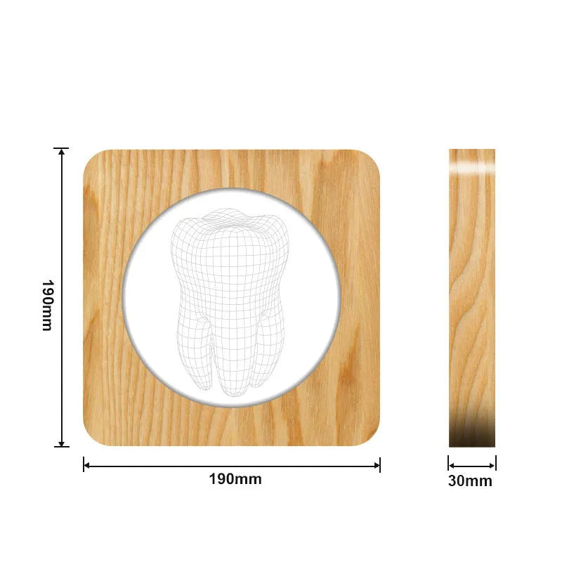 Wood colour tooth shaped acrylic night lamp with USB cable on wooden surface