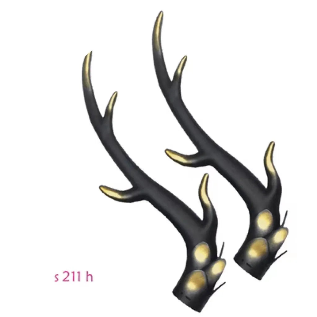 A pair of black resin dragon horn decorations for motorcycle helmet customisation, showing curved shape and mounting base.