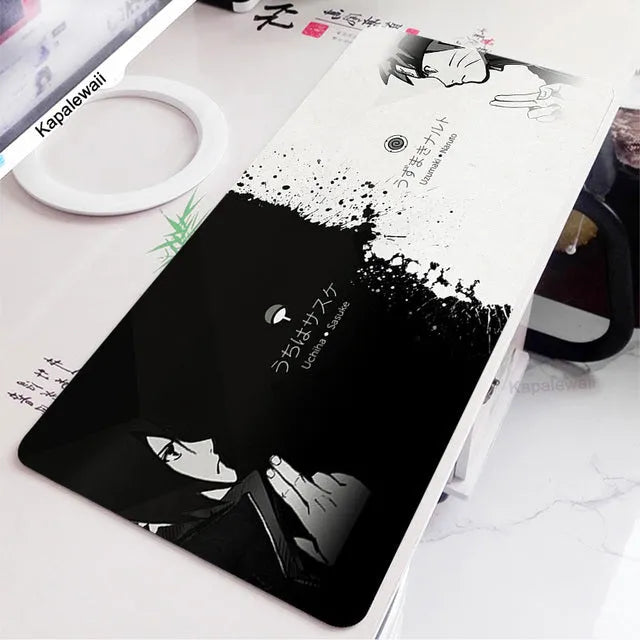 Large black and white gaming mouse pad with non-slip rubber bottom and cloth cover on a desk