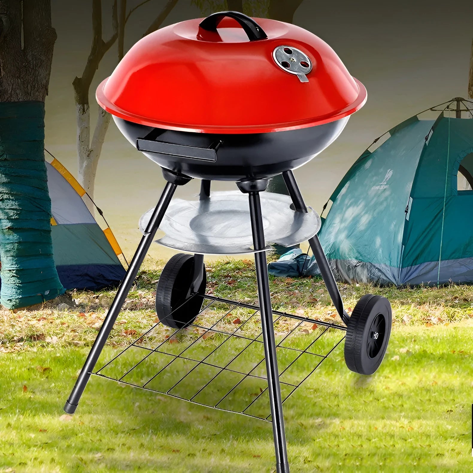 A compact, circular portable barbecue oven with a 14-inch cast iron grill grate, shown on a patio.