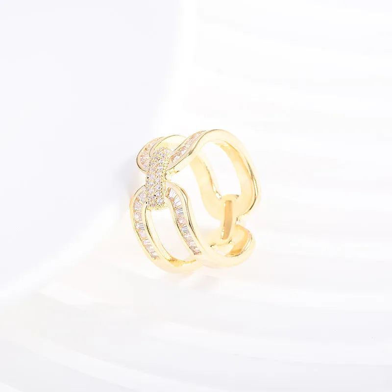 Gold electroplated copper round scarf ring with geometric shape on a silk scarf