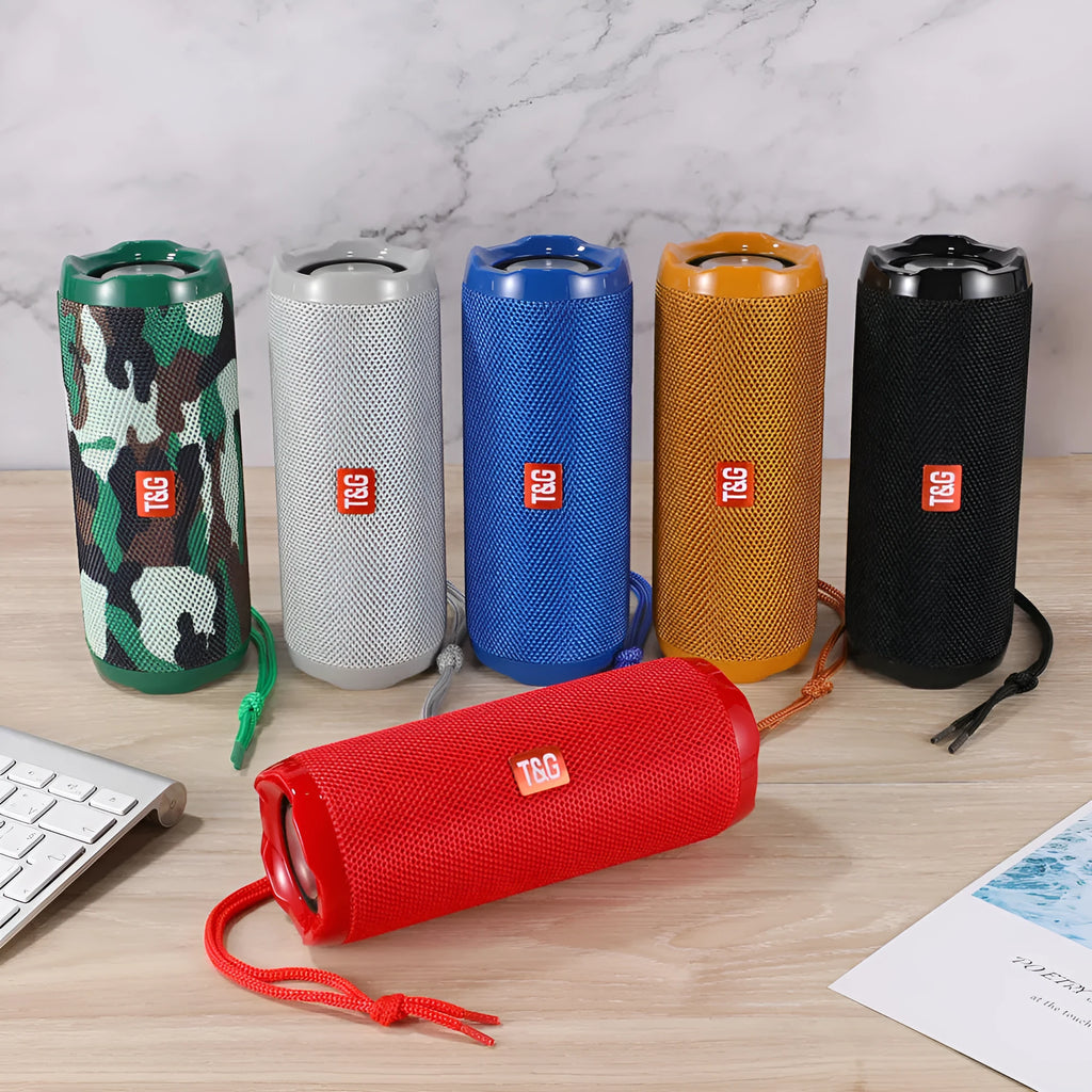 Fabric-covered portable Bluetooth speaker with a visible card slot in one of six colour options.