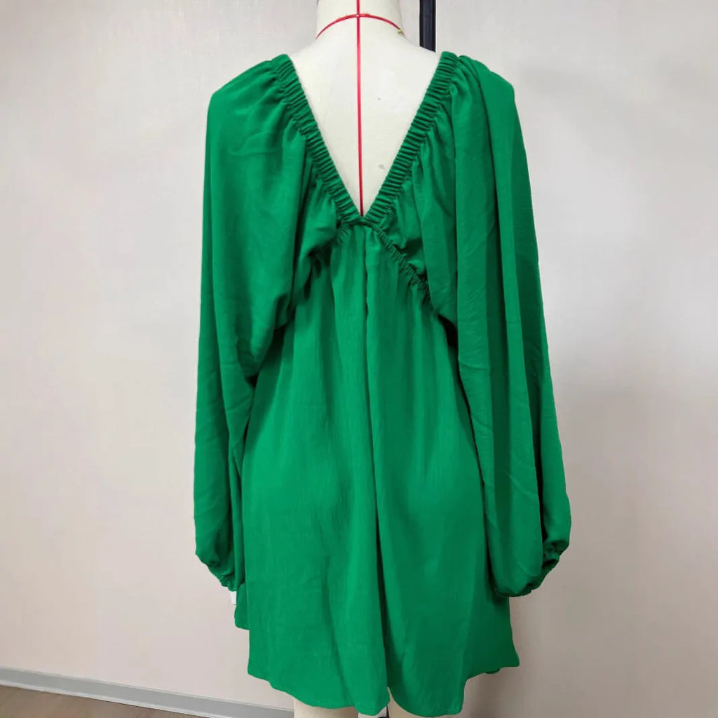 Women's apricot V-neck dress with long puff sleeves and a swing flounced skirt.