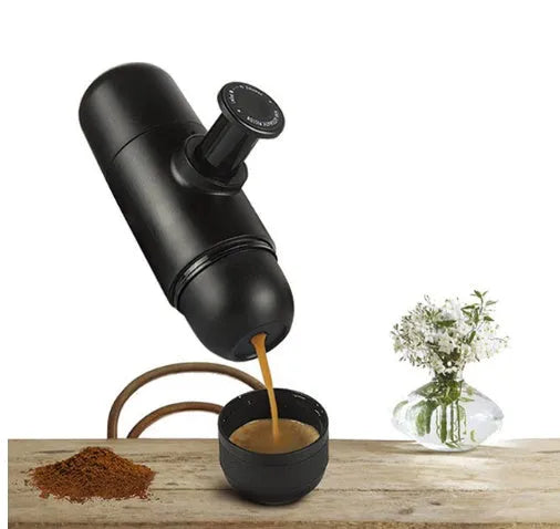 Black portable manual coffee machine measuring 6cm by 17.5cm on a table
