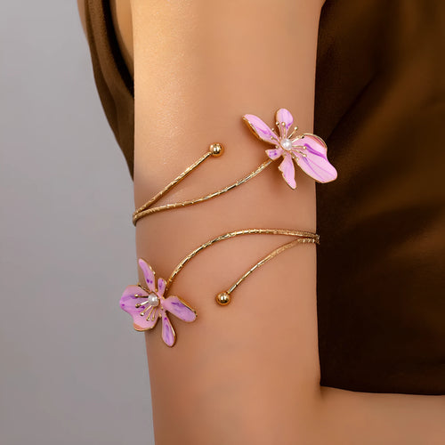 Pink adjustable alloy armband with hollow line pattern on a wrist, showing open-ended design.