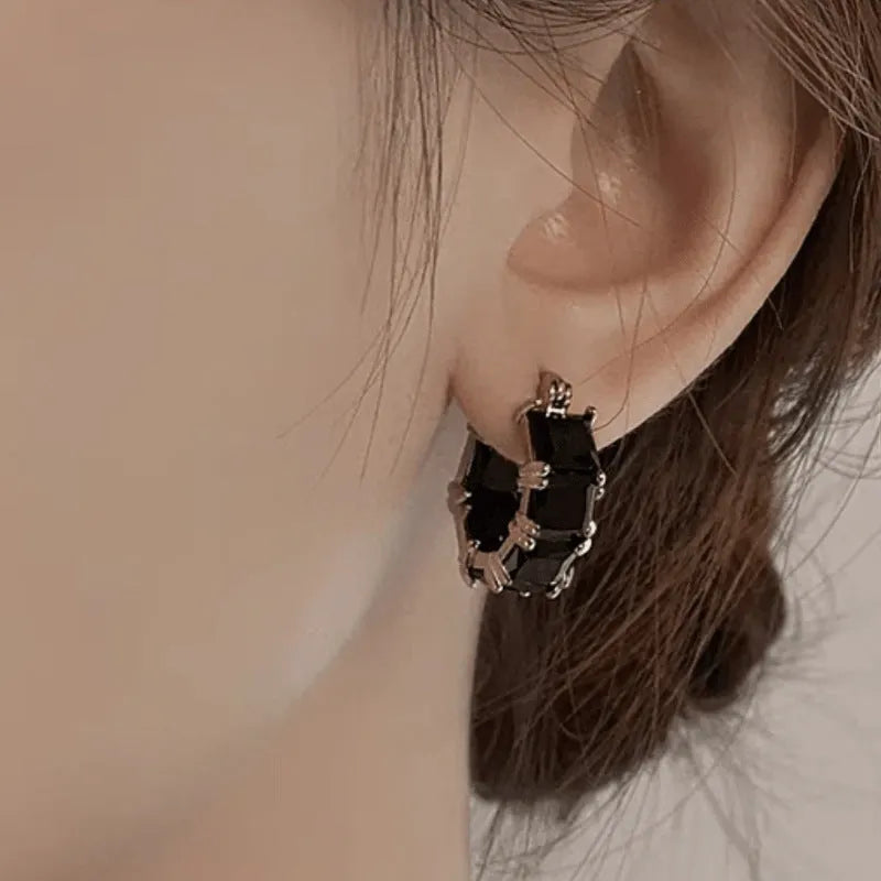 Geometric U-shaped copper earrings with round crystal zirconium accents in gold electroplated finish