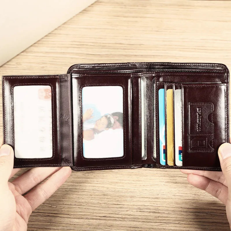 Men's black leather bifold wallet open, showing eight card slots, bill compartment, and a zip coin pocket