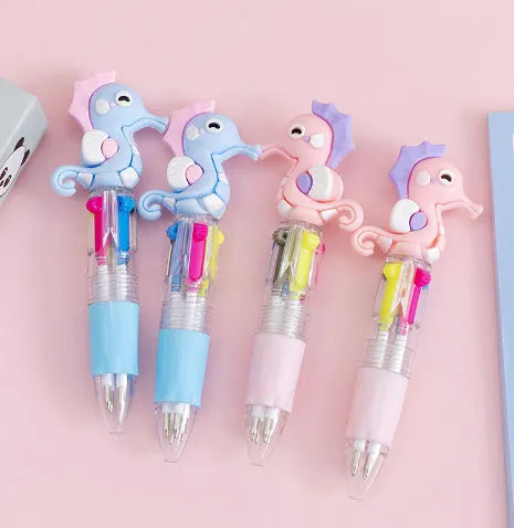 A four-colour ballpoint pen with a press top and a cute cartoon design on a silicone grip section.