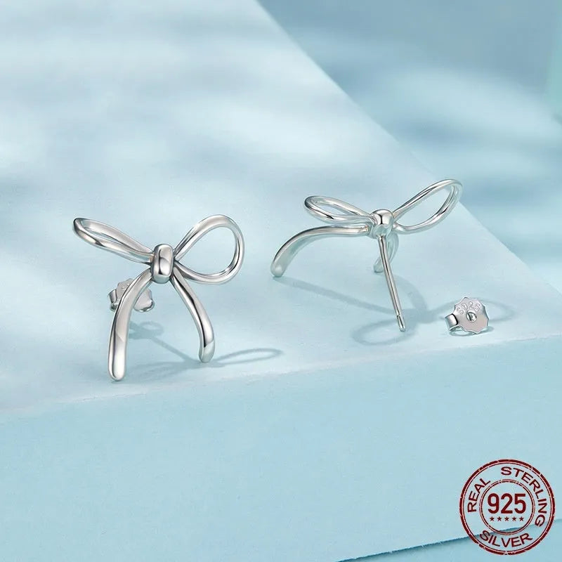 Simple S925 sterling silver stud earrings with polished finish on white background