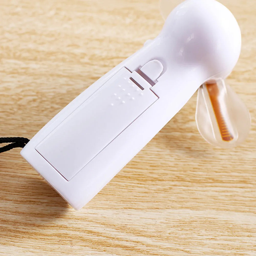 White handheld mini fan with flashing blue I Love You LED display, showing dimensions.