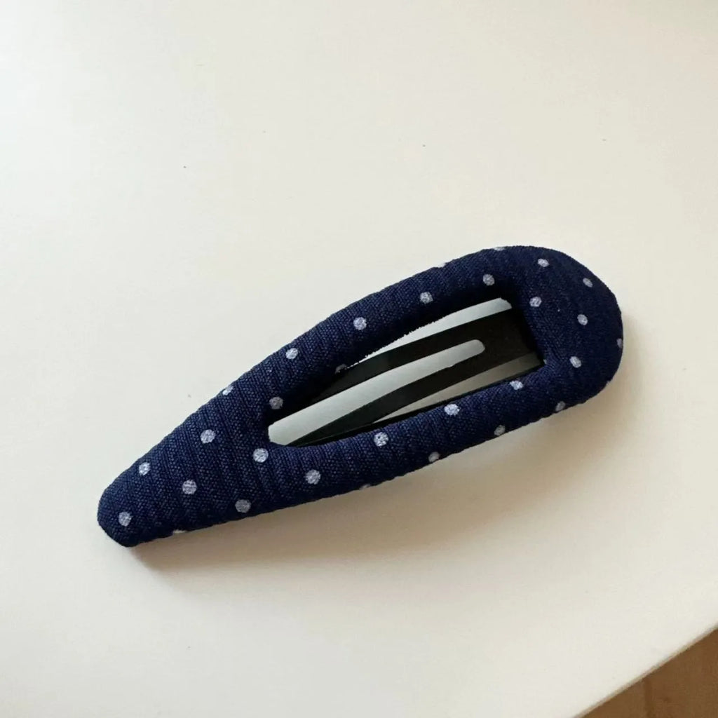 French retro style hair barrettes in triangle and water drop shapes with dark denim and polka dot patterns.