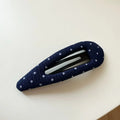 French retro style hair barrettes in triangle and water drop shapes with dark denim and polka dot patterns.