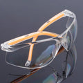 Transparent polycarbonate safety goggles with yellow tinted lenses for eye protection.