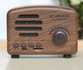 Vintage wood grain finish Bluetooth speaker with compact design on a wooden table.