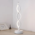Modern LED desk lamp with aluminium metal body and acrylic mask, gold colour, on a desk