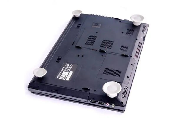 Four grey durable plastic laptop cooling pads, two large and two small, on a wooden desk.
