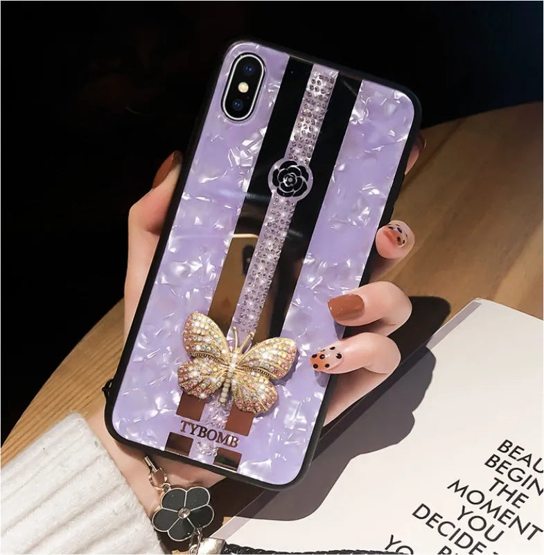 Pearl-coloured acrylic iPhone case with diamond patterns, butterfly design, and a central mirror panel.