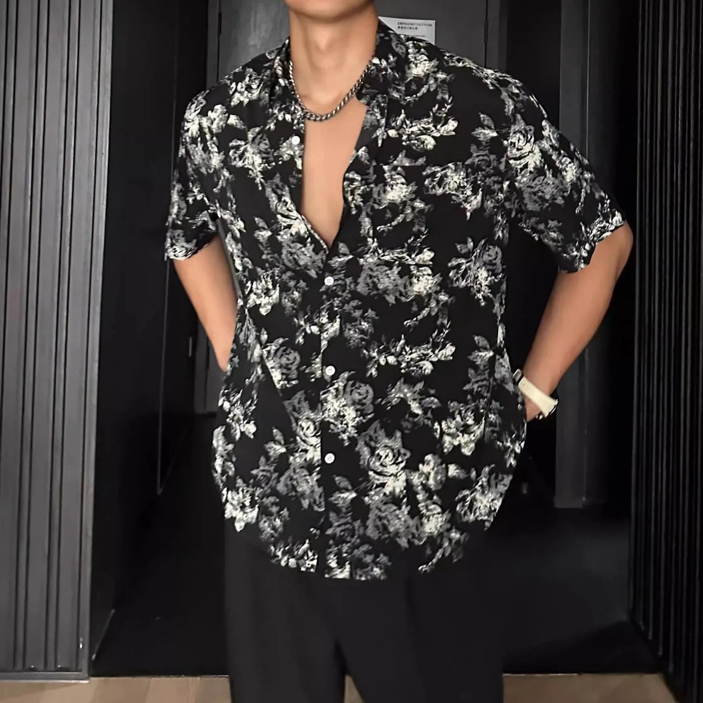 Women's loose-fit floral print short sleeve shirt in white, shown with a cardigan-style button front.
