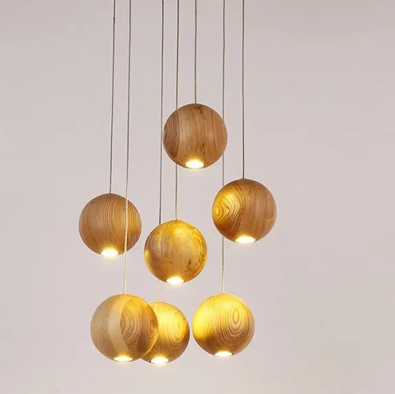 Nordic style wooden ball chandelier with solid wood construction hanging from a ceiling on an adjustable cord.