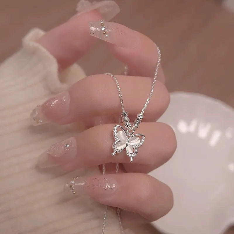Close-up of a women's silver butterfly necklace with opal stones on an adjustable 41-50cm chain.