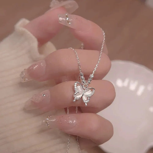 Close-up of a women's silver butterfly necklace with opal stones on an adjustable 41-50cm chain.