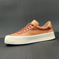 Boys black cowhide leather platform board shoes with a thick rubber sole and white stitching.