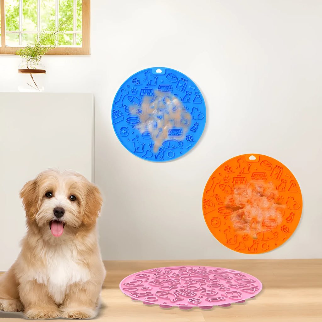 Round silicone pet licking mat in blue colour with suction cup base on a tile floor.
