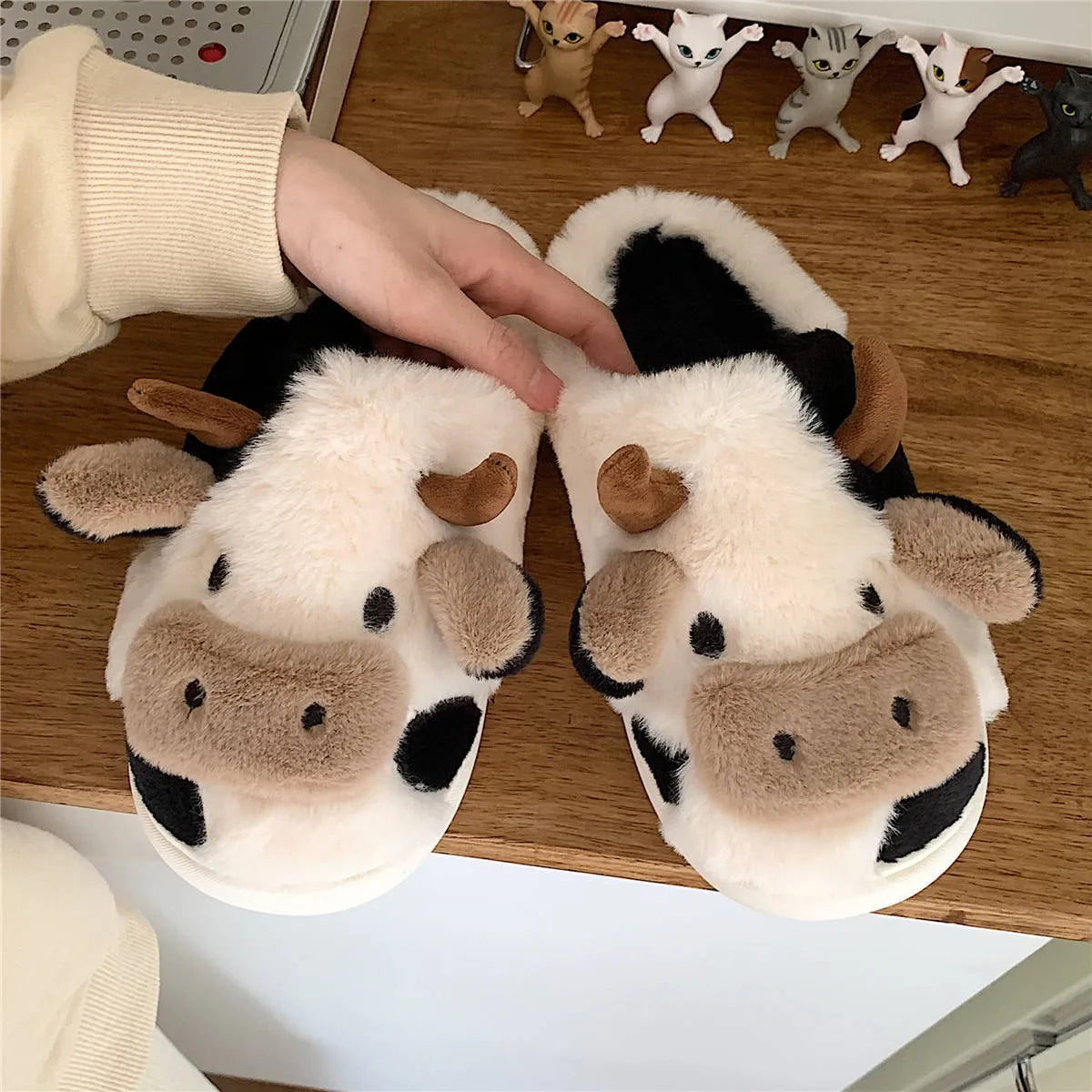 White cow plush slippers with cartoon milk cow pattern and non-slip textured sole