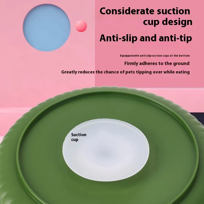 Grey interactive pet slow feeder bowl with rotating centre holding a green silicone licking mat on a kitchen floor.
