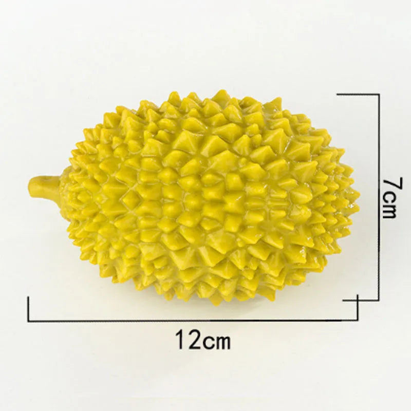 Beige, green and yellow durian-shaped dog chew toy with raised texture for dental cleaning