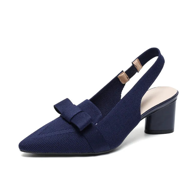 Women's black closed toe high heel sandals with a bow detail and an ankle strap on a rubber sole.