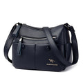Soft black PU leather women's crossbody bag showing external pockets and a horizontal square shape.