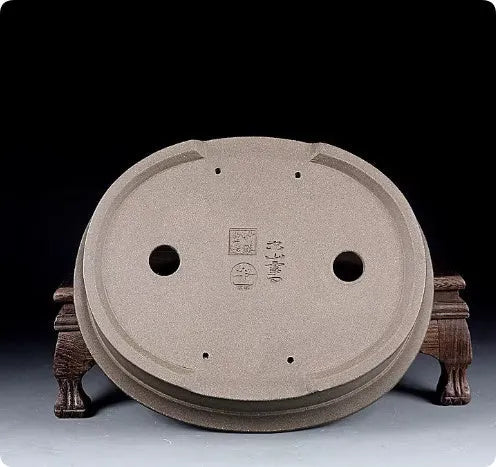 Handmade oval purple sand ceramic bonsai flower pot measuring 25 by 21 by 6.3 centimetres.