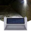 Solar-powered outdoor motion sensor step light in an abstract design.