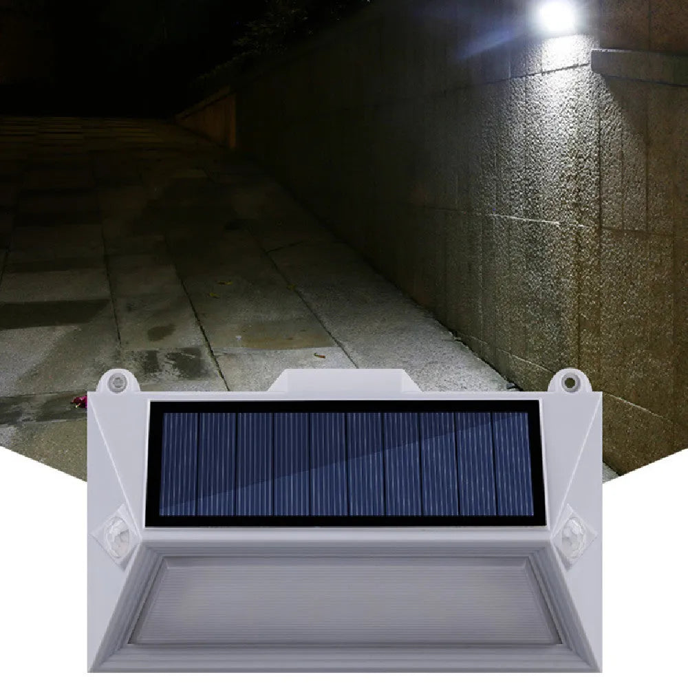 Solar-powered outdoor motion sensor step light in an abstract design.