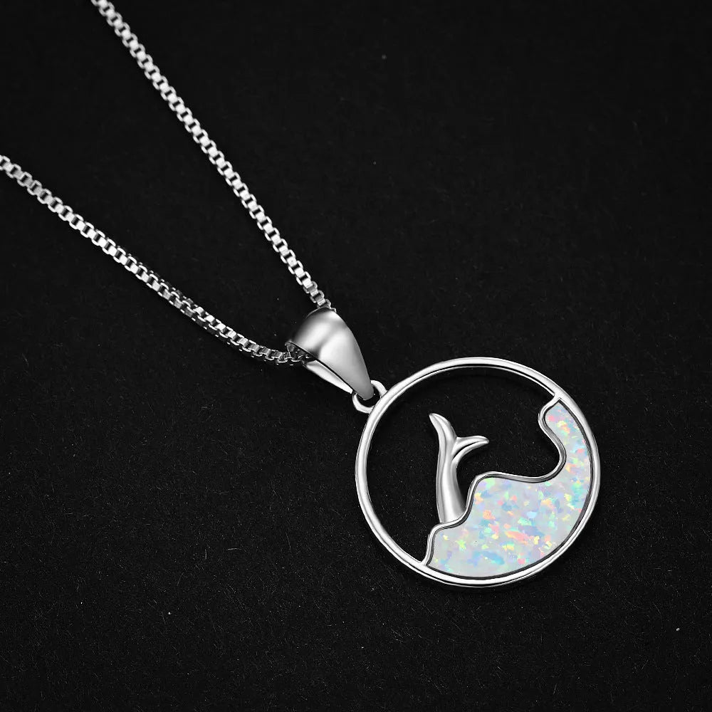 A round geometric pendant necklace with an electroplated opal finish on a copper chain.