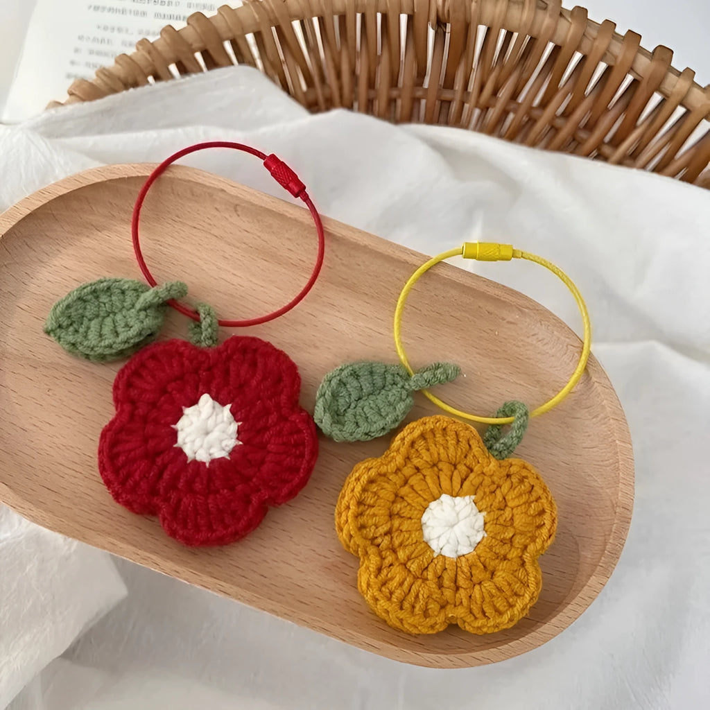 Hand-crocheted wool pendant in small flower design, available in red or yellow colours