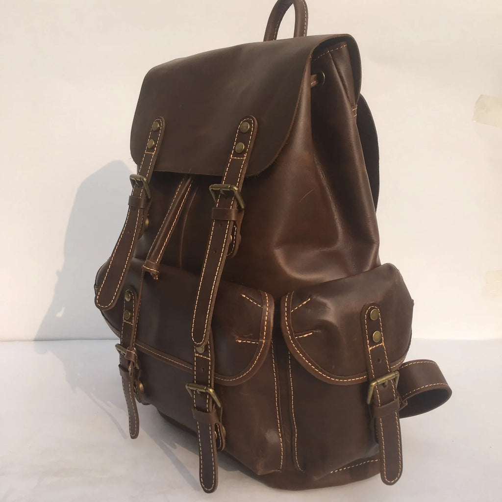 Brown men's cowhide leather backpack with air pillow shoulder straps and a single main compartment.