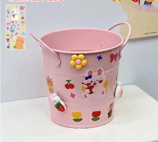 Round metal desktop pen holder storage box in a choice of colours including pink, green, red, white, and yellow.