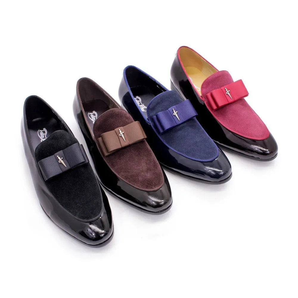 Men's black tassel loafer shoe with matte leather and glossy patent leather detail on a white background.