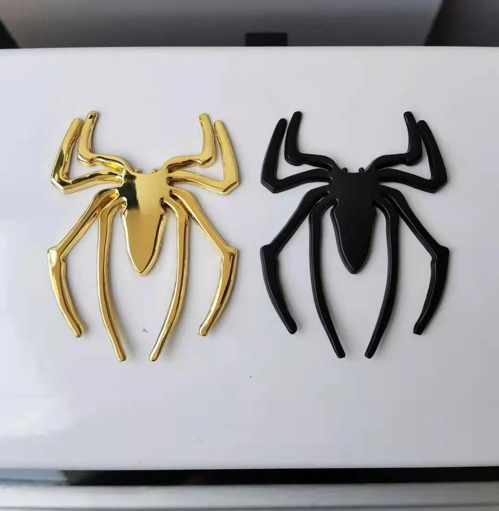 Three-dimensional metallic spider sticker in gold, silver, black, and red colours