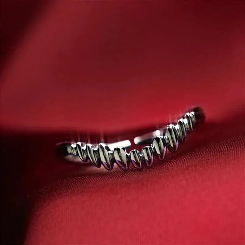 Silver vampire split open ring on finger showing adjustable opening and zinc alloy construction