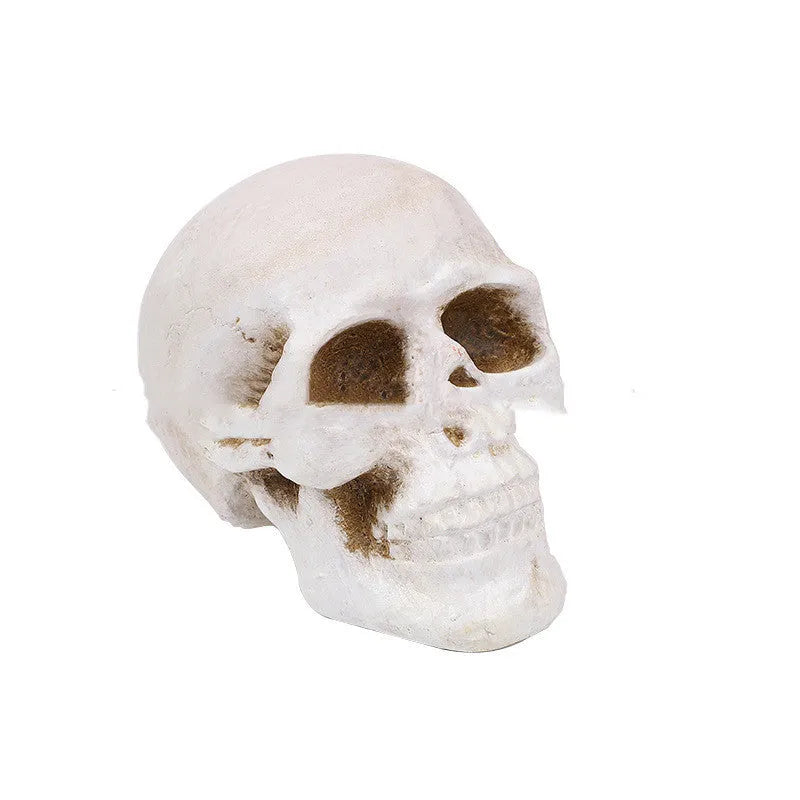 White ceramic skull barbecue model ornament on a flat surface.