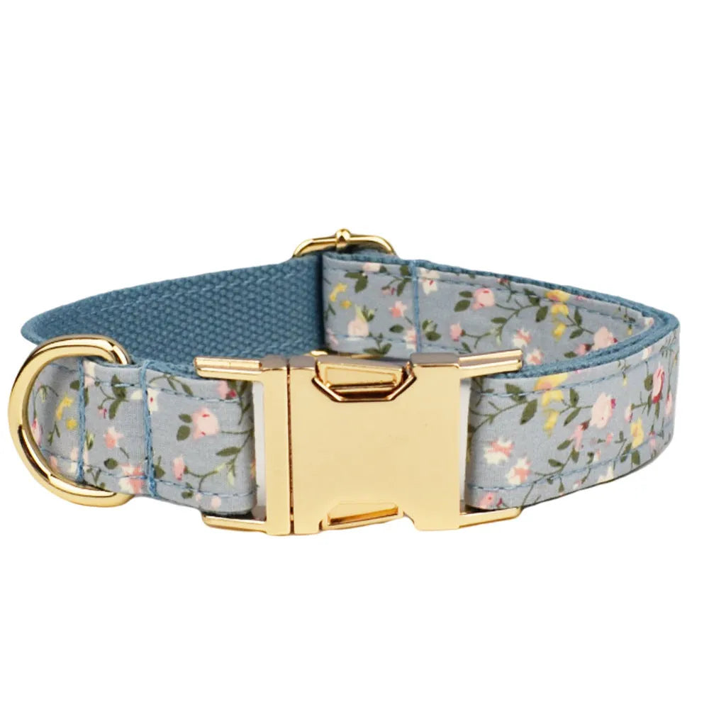 Floral print dog collar and leash set with matching bow, vest, and poop bag holder.