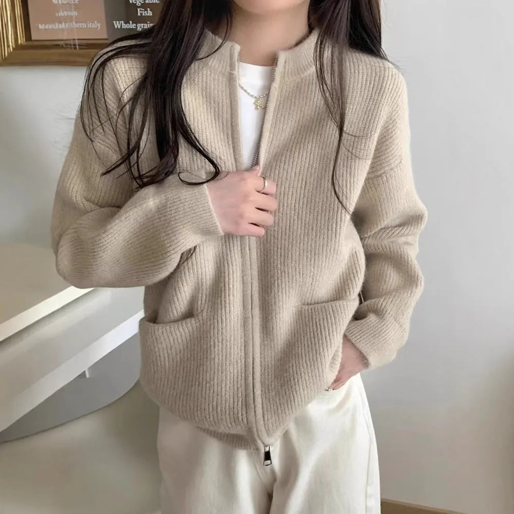 Beige viscose fibre sweater coat cardigan with long sleeves laid flat.