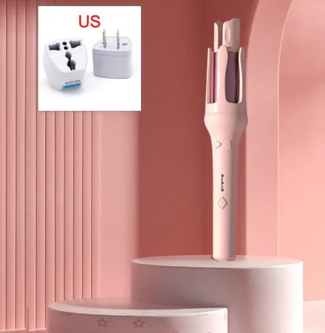 White and pink automatic hair curler with a 32mm rotating ceramic barrel and clamp, resting on a table with international power adapters.
