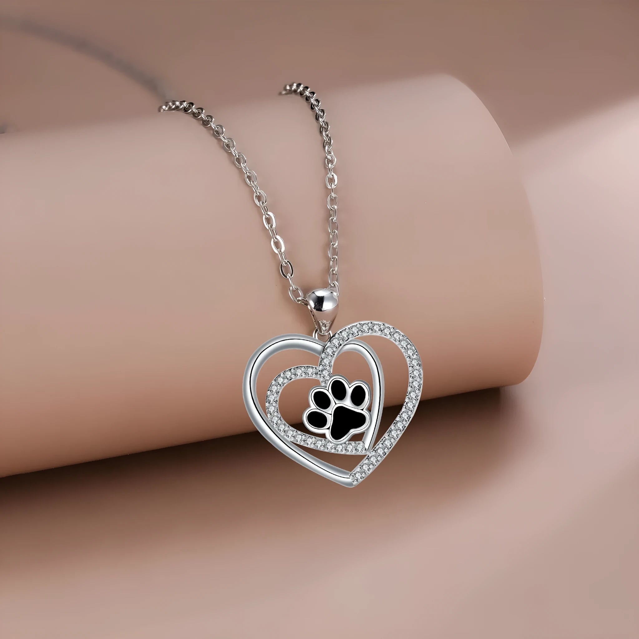Women's copper necklace with dog paw print and heart pendant on cross chain