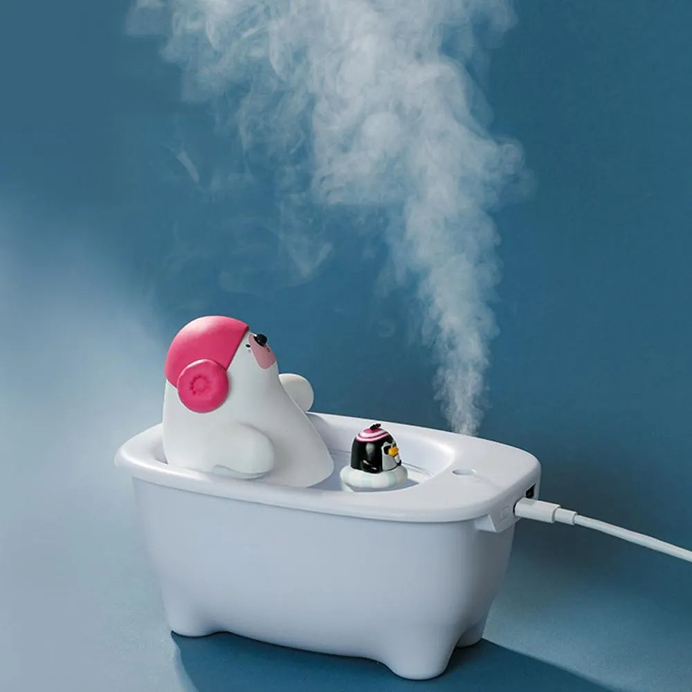 White compact USB air humidifier with large water tank on a desktop.
